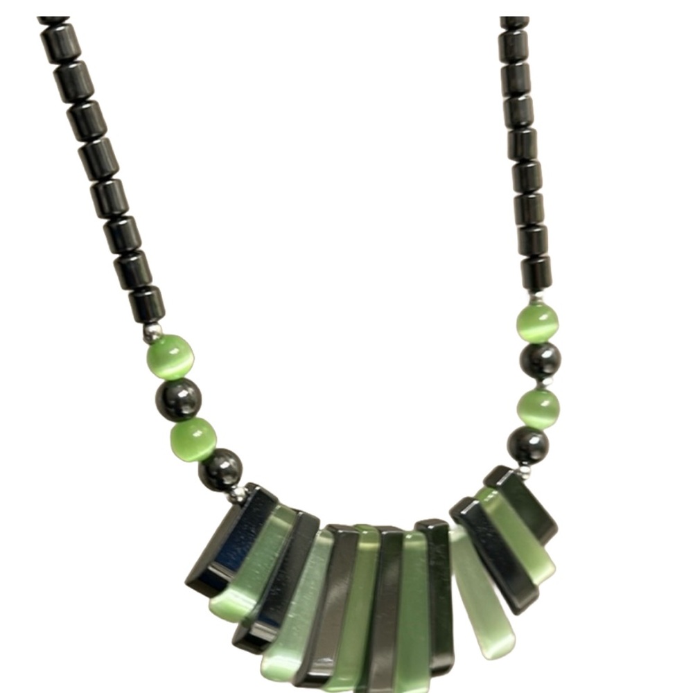 Woman’s beautiful metal and green stone necklace.